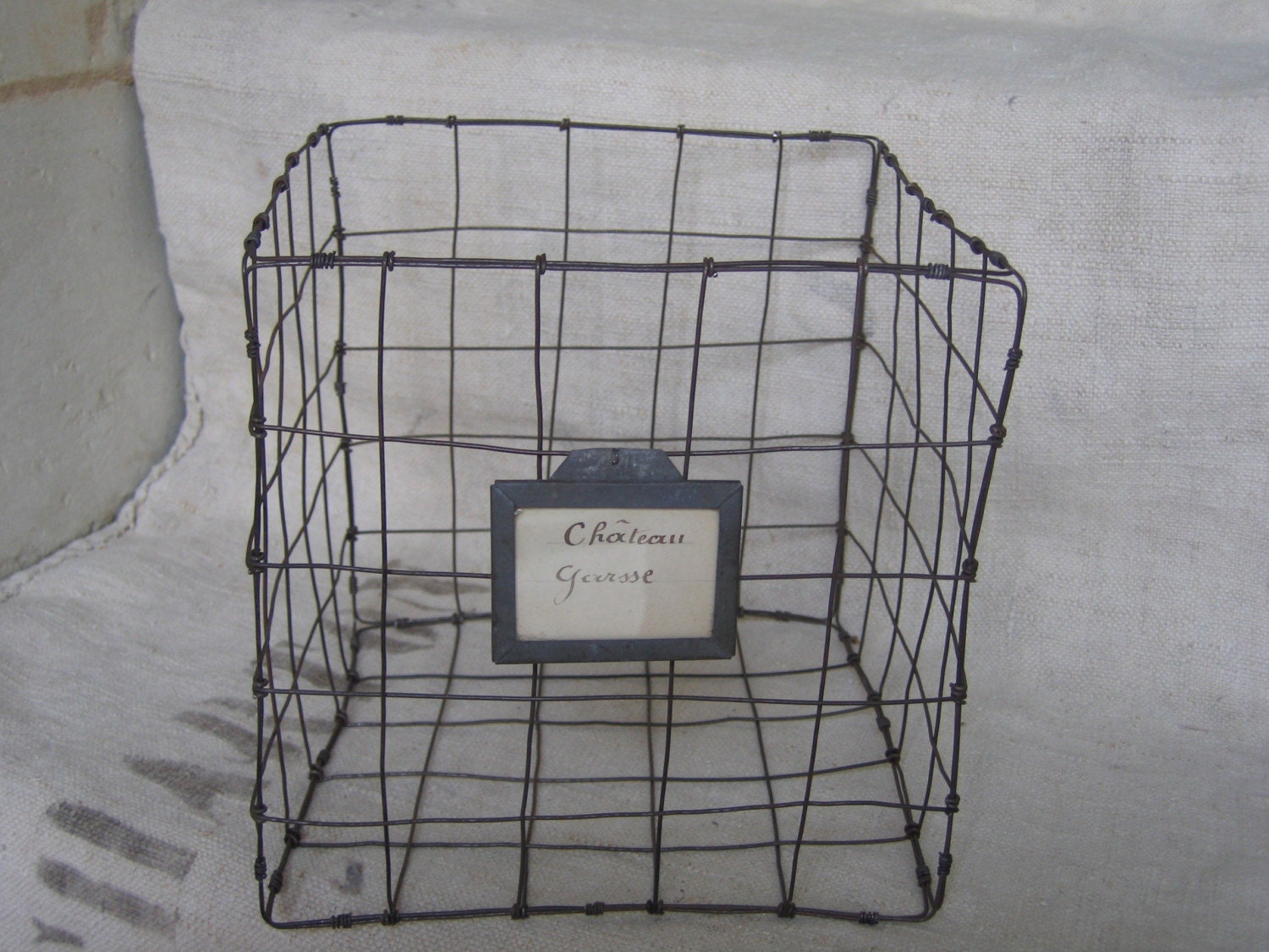 WIRE BASKET with vintage zinc label of wine cave