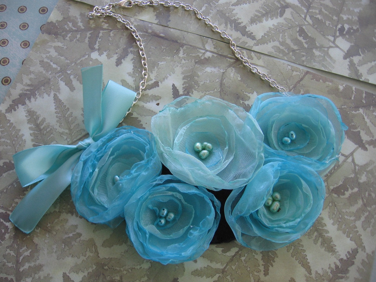 Soft and feminine fabric flower bib style statement necklace