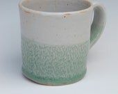 Green and Blue Celadon stoneware mugs. Each one has different incised decoration