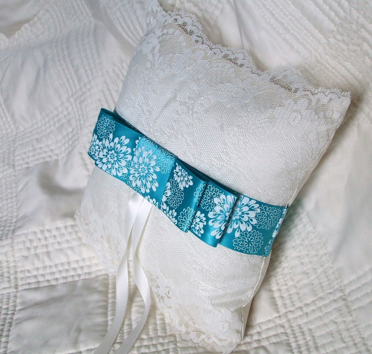 Cream silk wedding ring pillow with beautiful blue ribbon