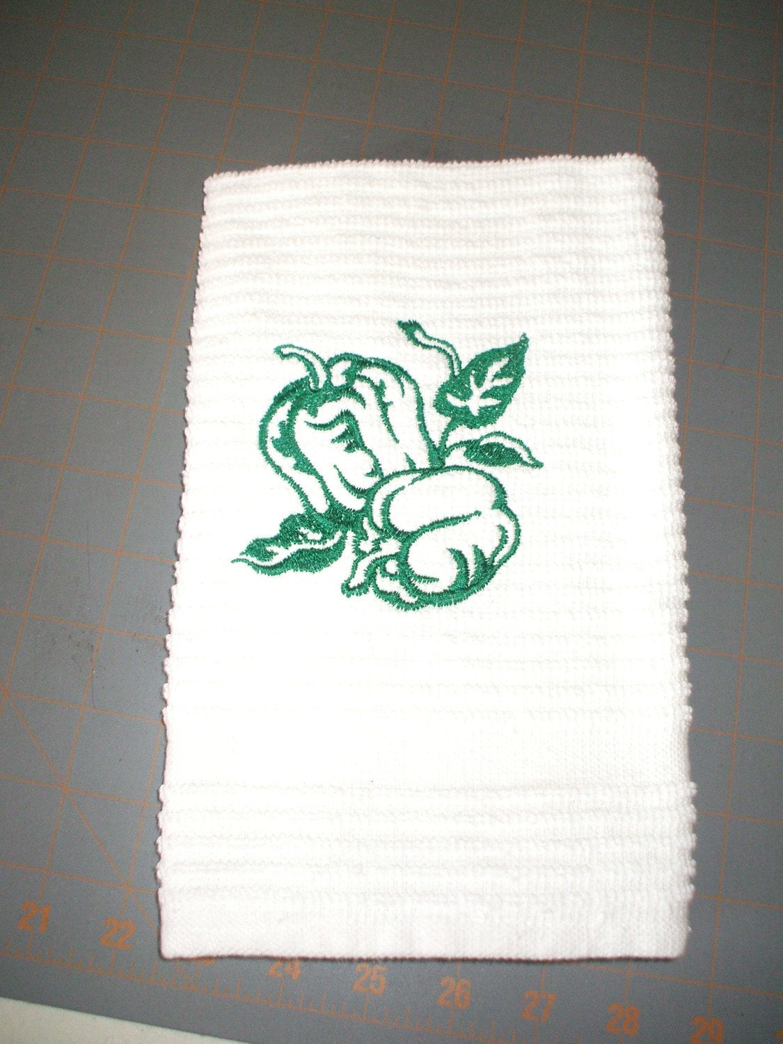 embroidered kitchen towel with green peppers