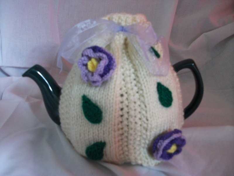 Hand Knitted cream tea cosy with purple/lilac flowers and green leaves. UK seller