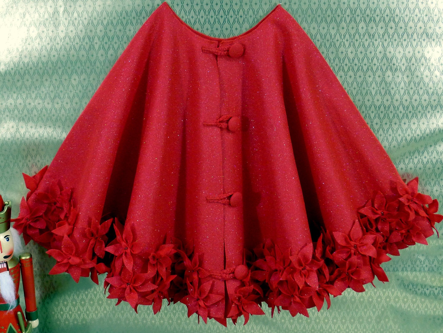 Christmas tree skirt in red glitter felt with hand cut and hand sewn flowers at the hem. 50