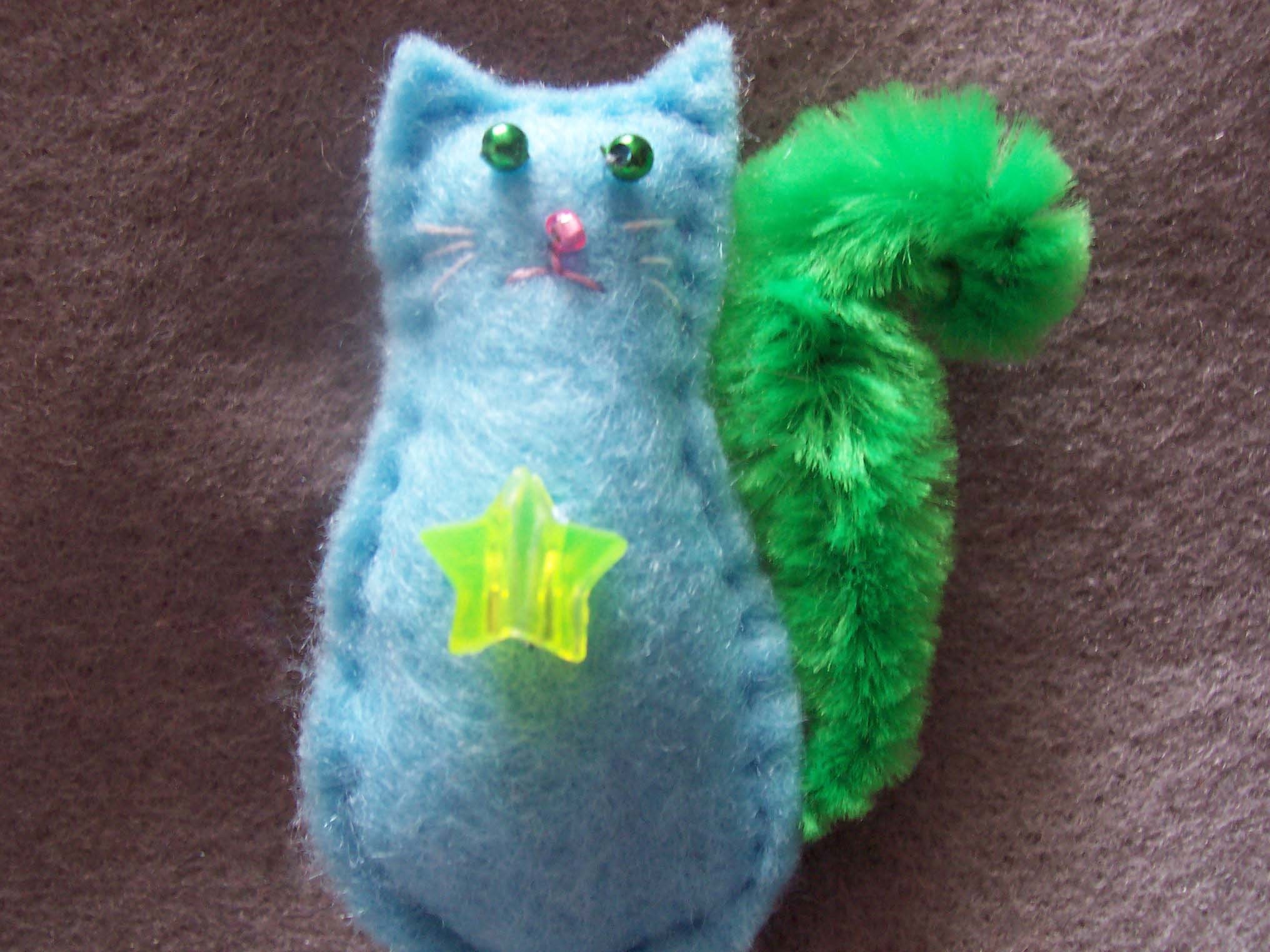 Adorable Baby Blue Felt Cat Crooch. With a Very Fluffy, Bright Green Tail and a Flourescent Green Star Bead.
