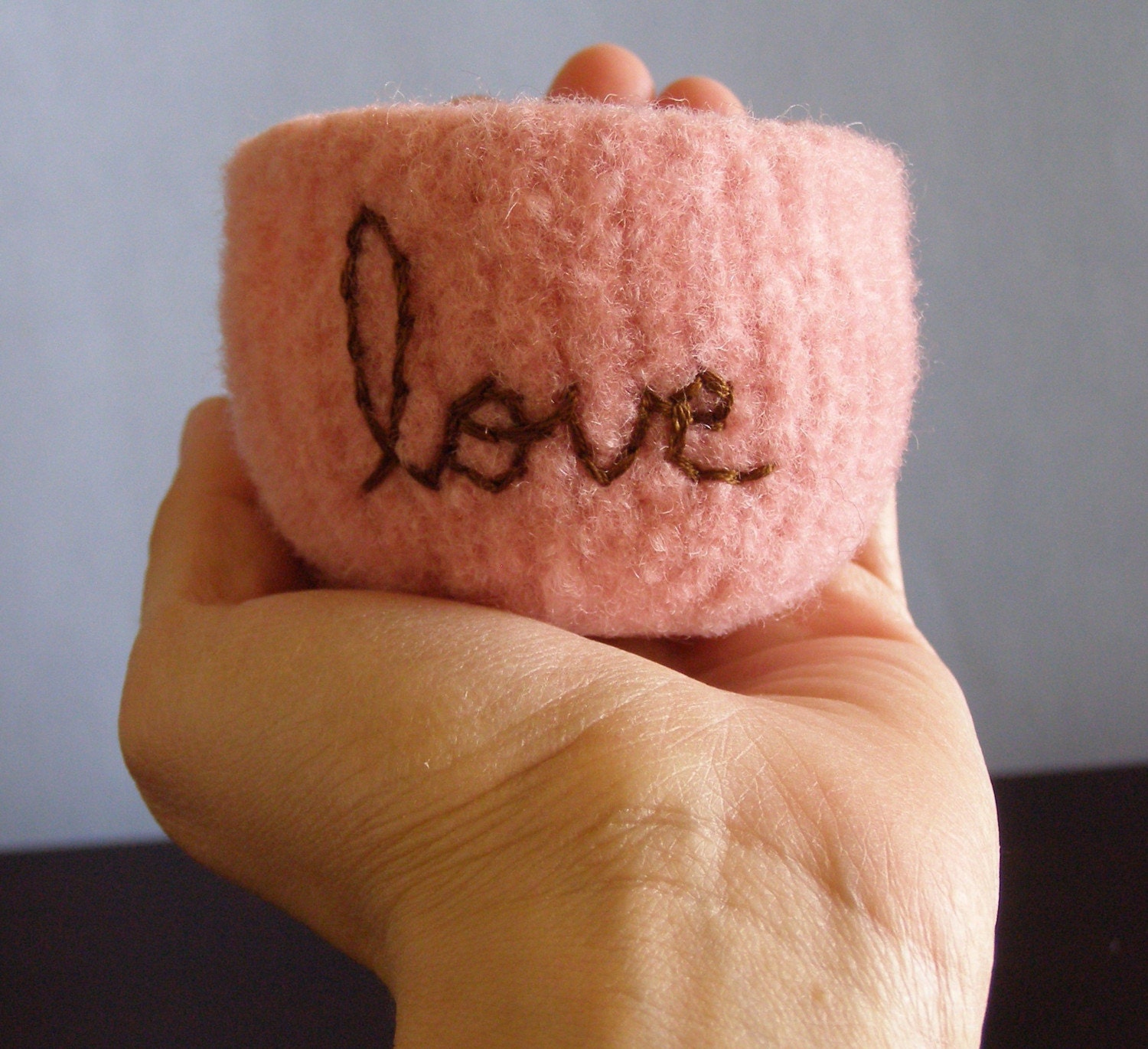 fuzzy felted pink wool bowl with the word love embroidered in milk chocolate brown