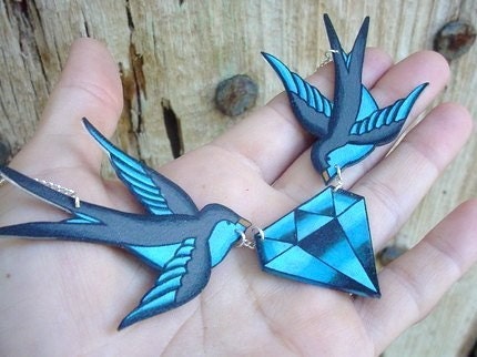 tattoo inspired blue and grey sparrows holding diamond necklace