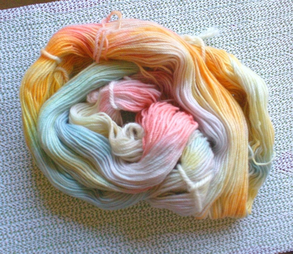 An unwound hank of yarn, showing the long loops of hand dyed yarn
