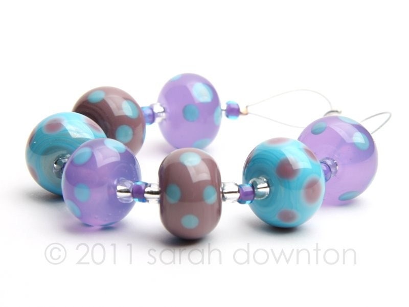A mixed set of 7 beads all decorated with coordinating colour dots.