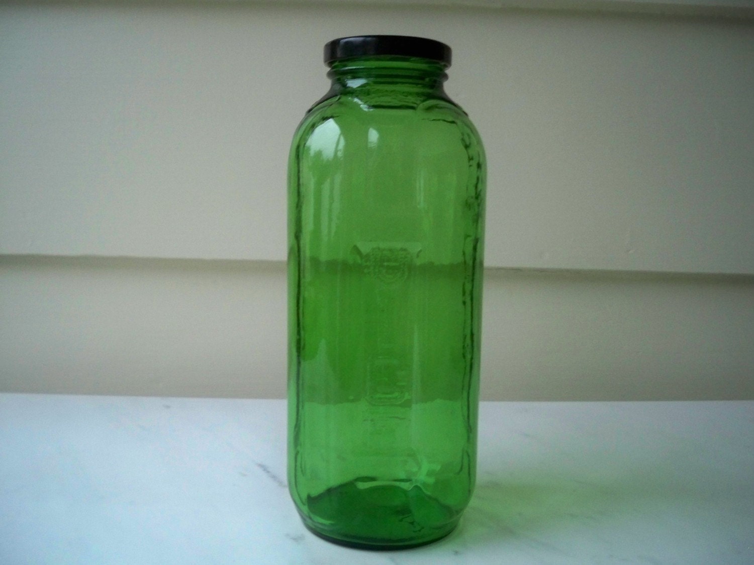 Emerald green glass juice/water bottle with black metal lid