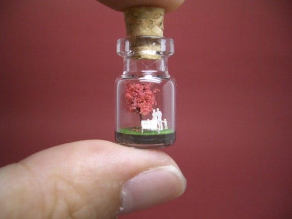 Tiny red tree and a family in a tiny bottle
