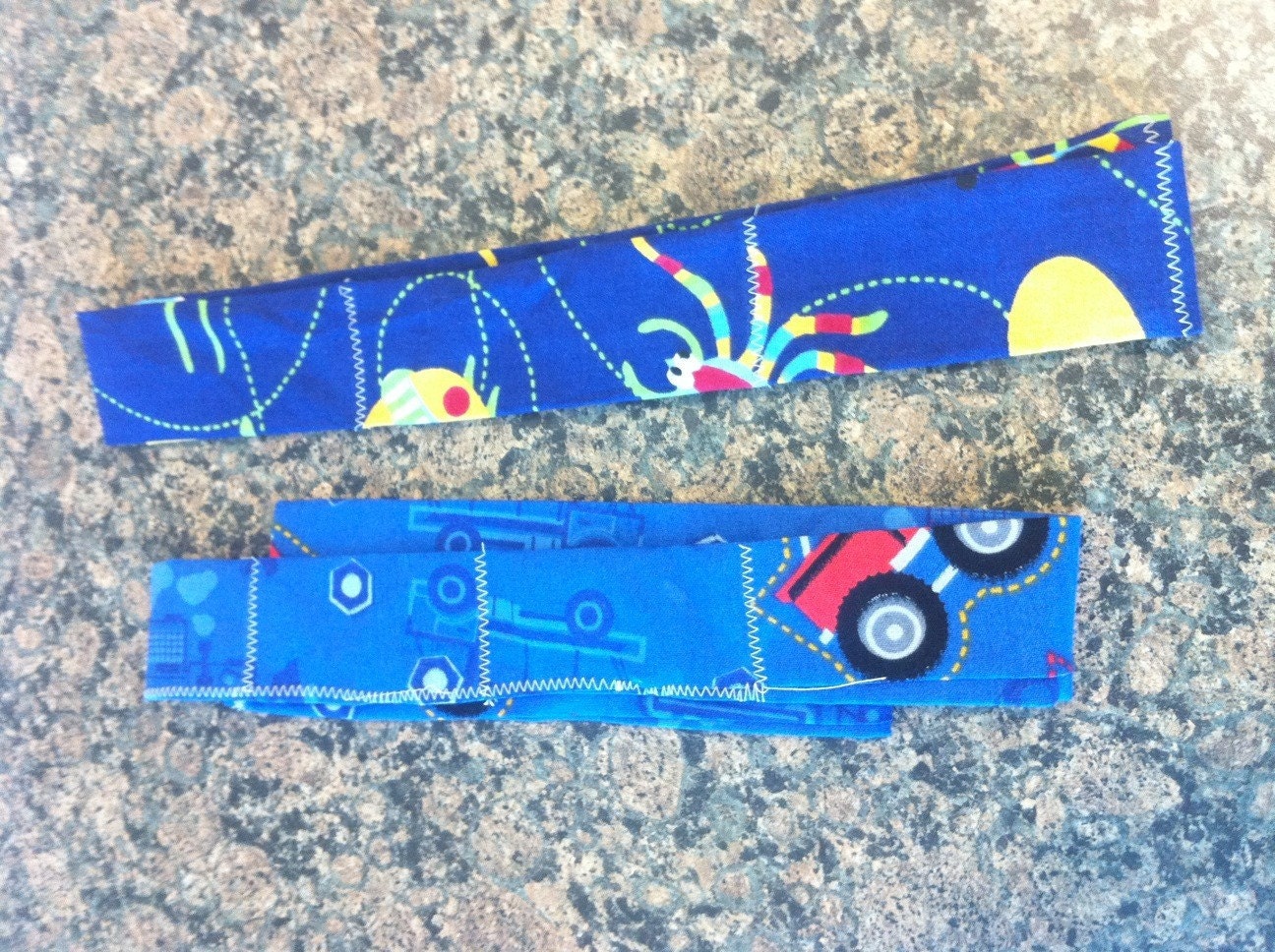 2 boys col neck bands colling scarves bugs and trucks