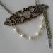 Lady of the Manor (brass filigree piece with mother of pearls flower, white pearls and brass chain strands)
