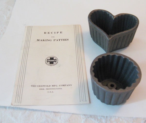 2 cast iron patty molds made by the 
