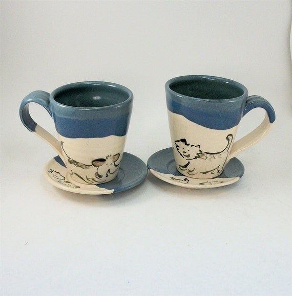 pair of dog and cat cups and saucers